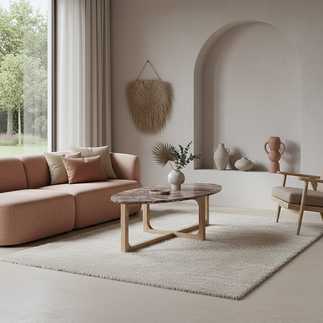Kayu Living Bizar oval marble coffee table with a veined top and light mango wood cross-frame in a modern living room.