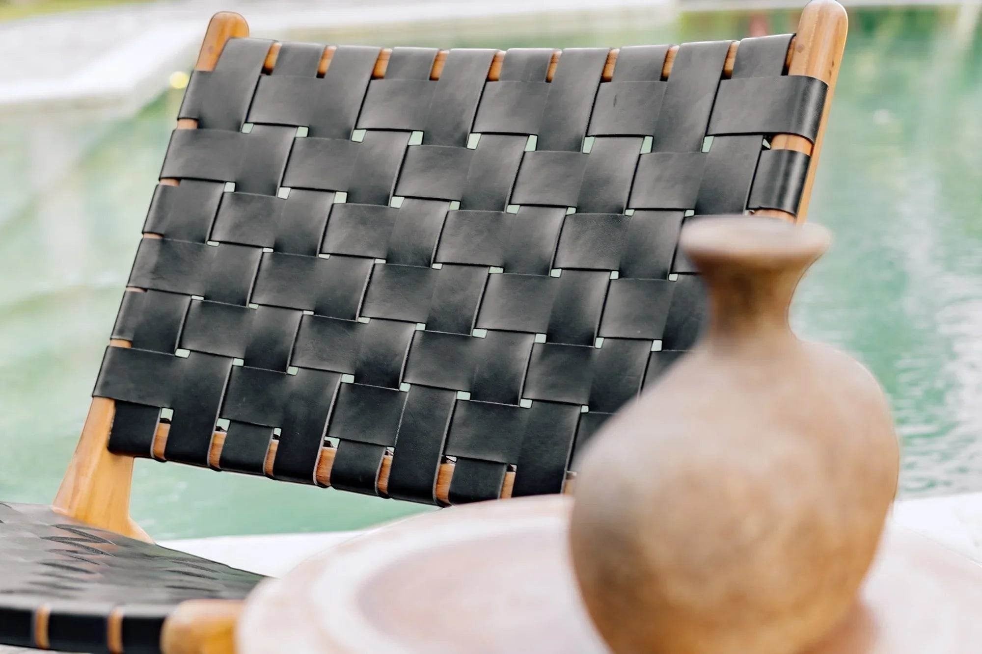 Kayu Living black handwoven leather lounge chair with teak frame, perfect for modern living spaces.