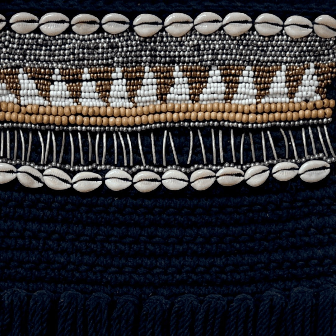 Kayu Living black macrame wall hanging with beads, shells, and fringe. 70x30 cm.