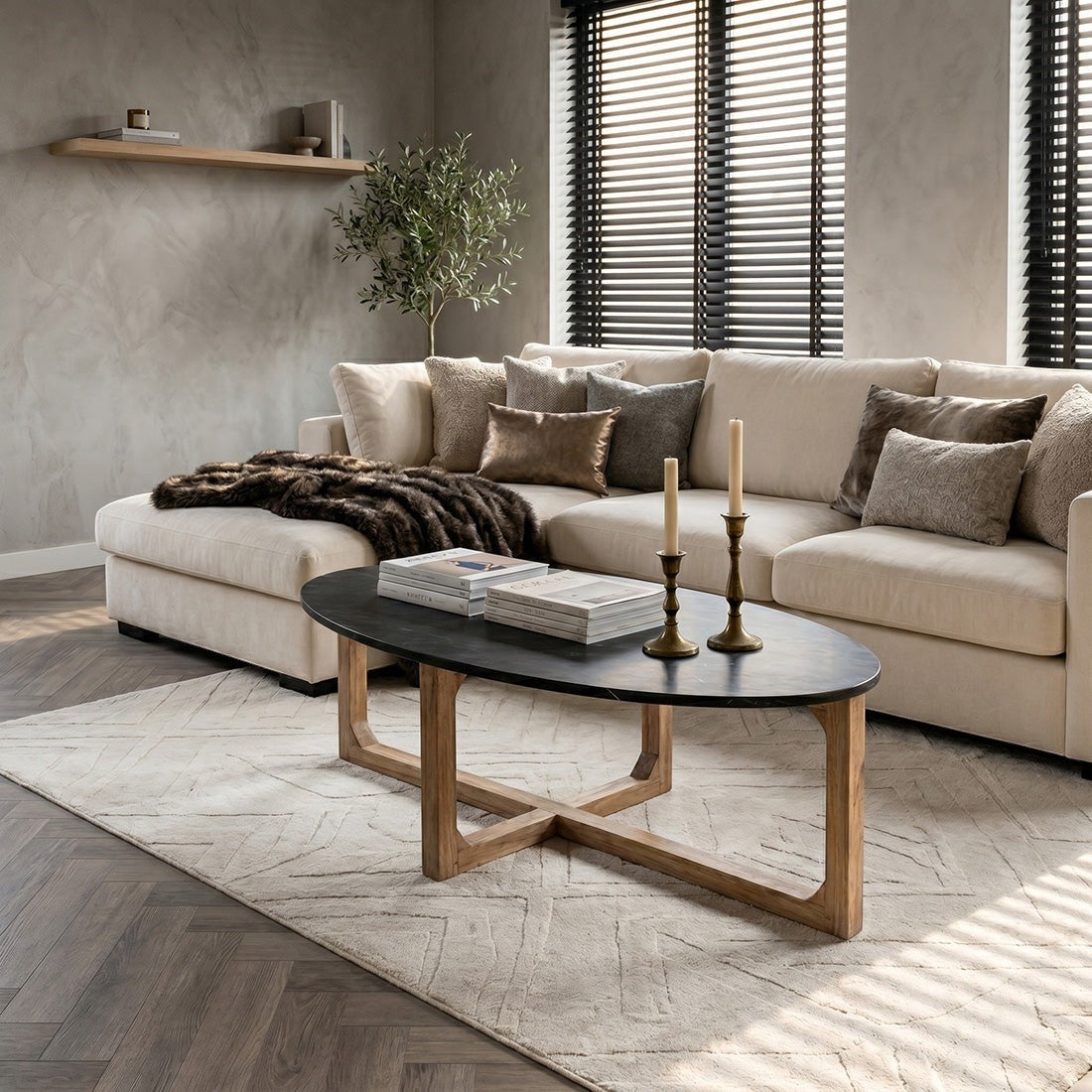 Kayu Living oval black marble coffee table with a sustainable mango wood crossed base in a modern living room.