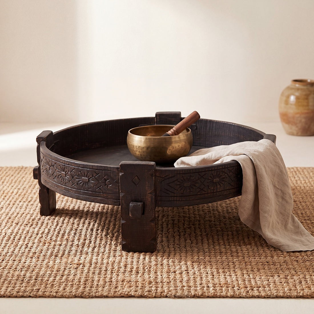Kayu Living black hand-carved recycled wood Chakki side table with a low profile and intricate decorative carvings.