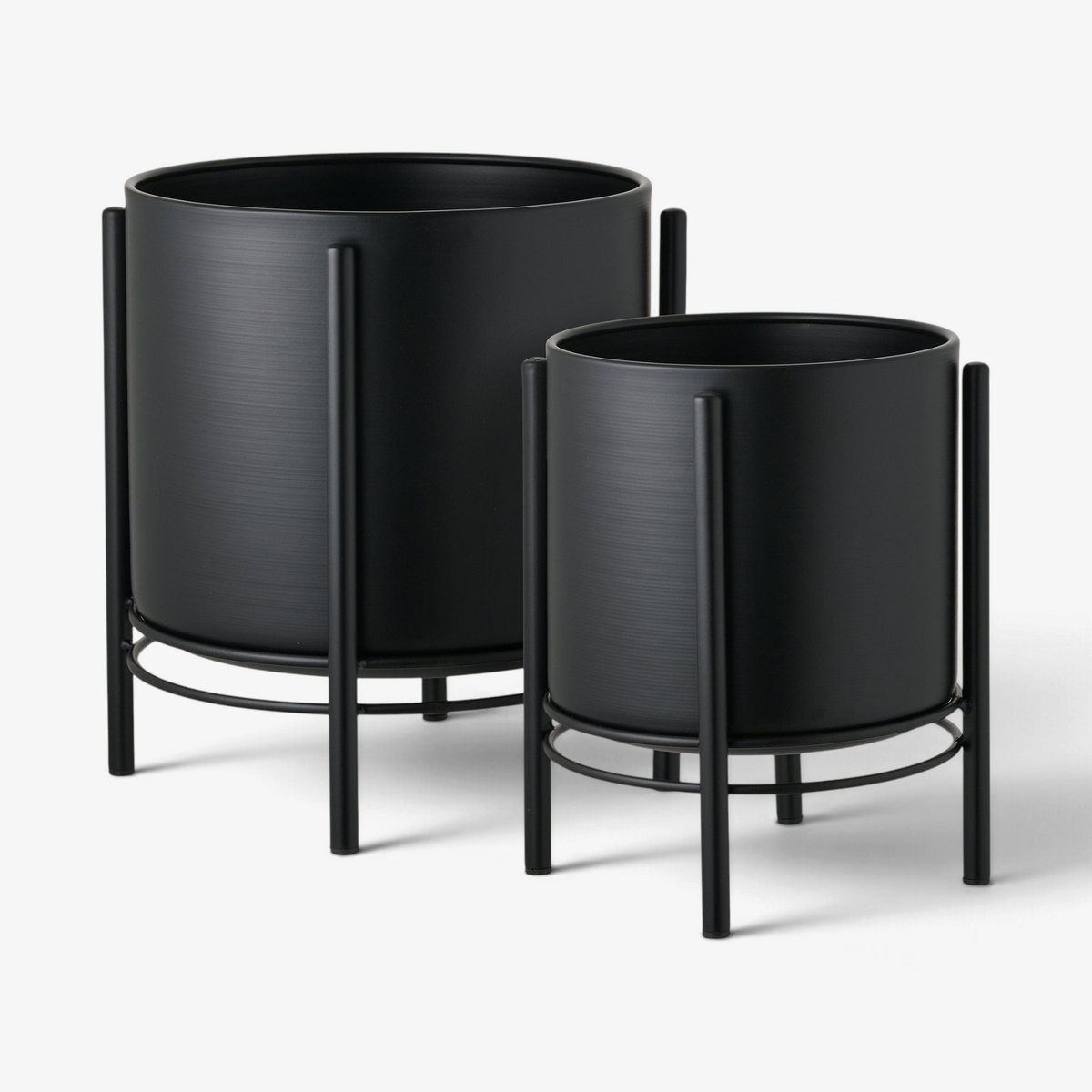 Kayu Living set of two sleek black steel flowerpots on minimalist metal stands against a white background
