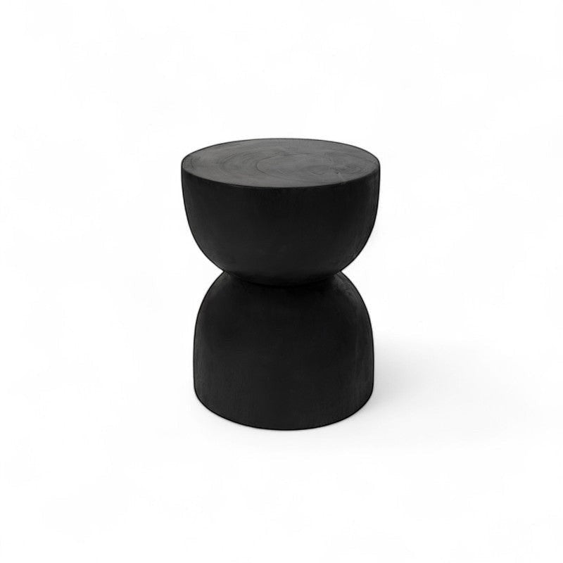 Kayu Living black hourglass stool made from solid suar wood, handcrafted by artisans in Java.