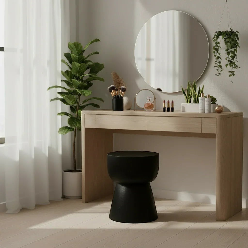 Kayu Living black cupped stool, handcrafted from solid suar wood with a unique hourglass shape, perfect for a vanity or accent seating.