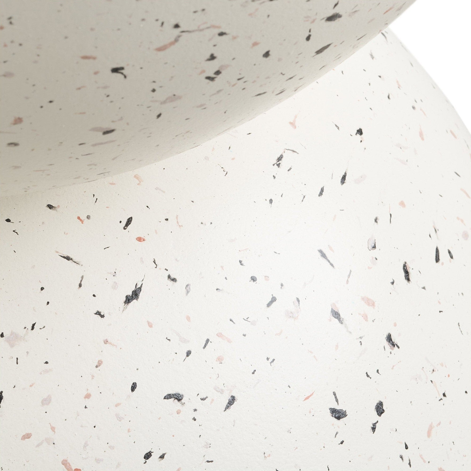 Kayu Living Bonita side table in off-white fiberclay with a speckled terrazzo-style finish and curved silhouette.