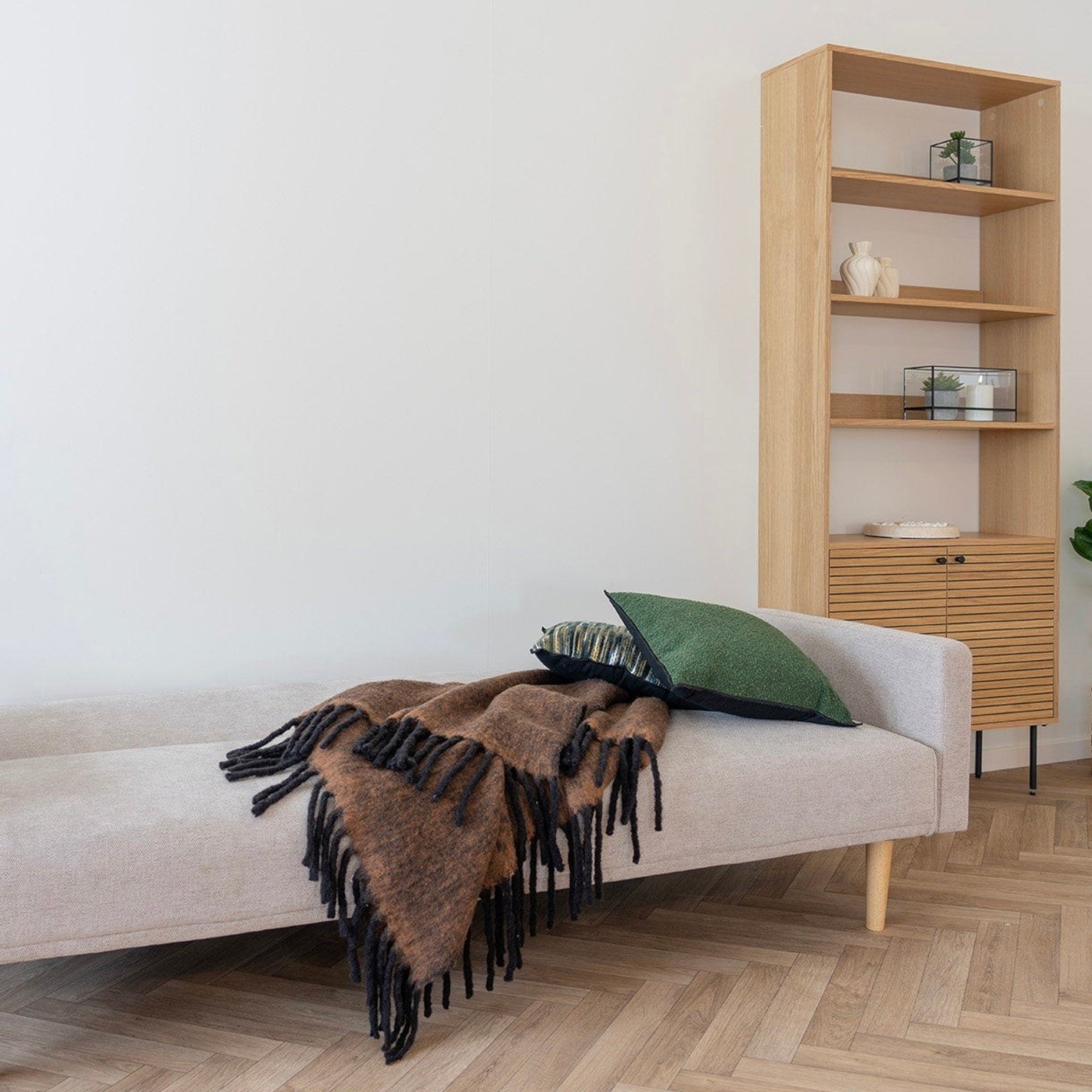 Kayu Living Carmel Plaid brown wool-blend throw blanket draped over a light beige sofa in a modern living room