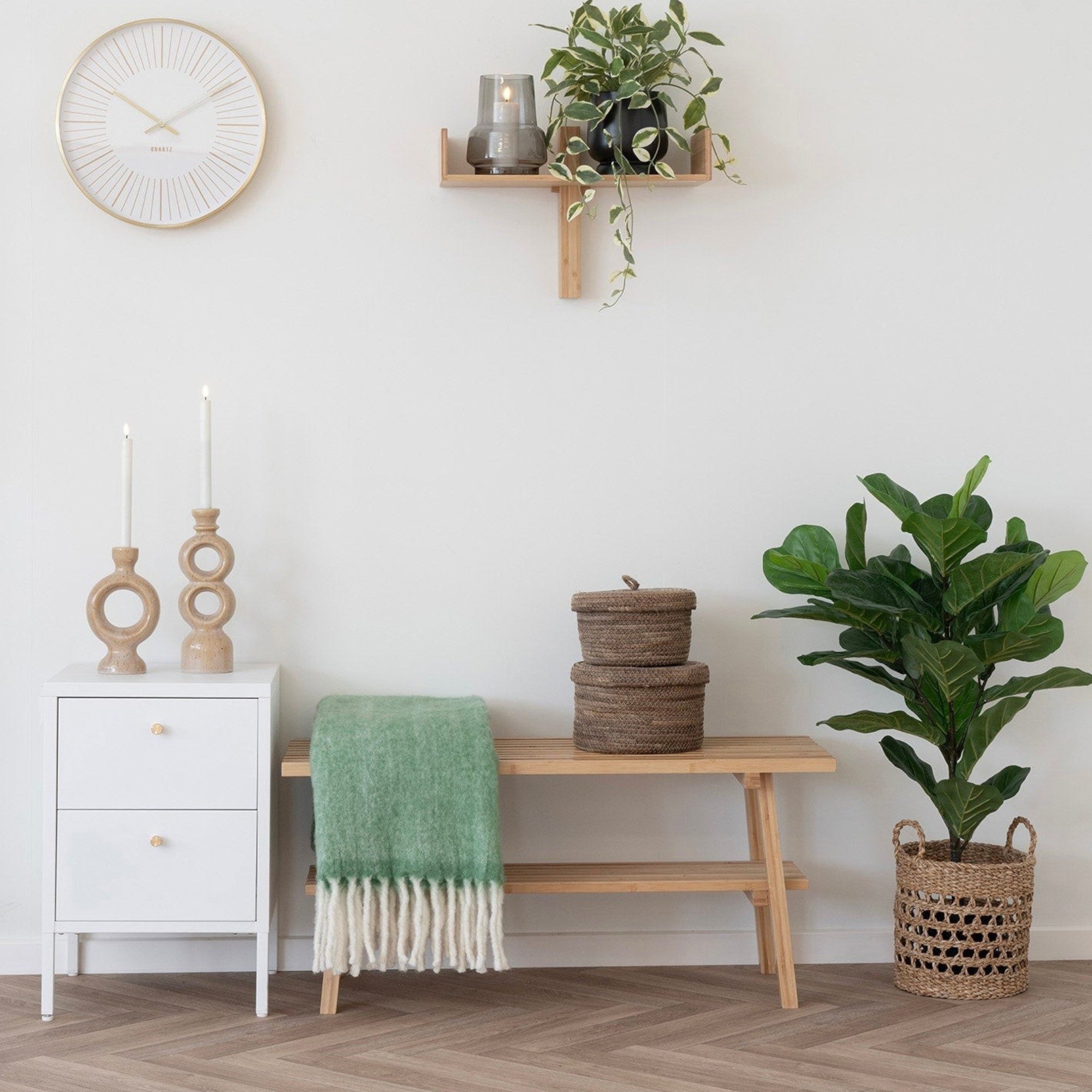 Kayu Living Carmel Plaid green wool-blend throw with fringe draped over a wooden bench in a cozy living room setting.