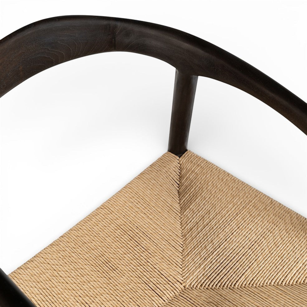 Kayu Living Cemagi chair with dark brown teak frame and handwoven natural rope seat, suitable for indoor/outdoor use.