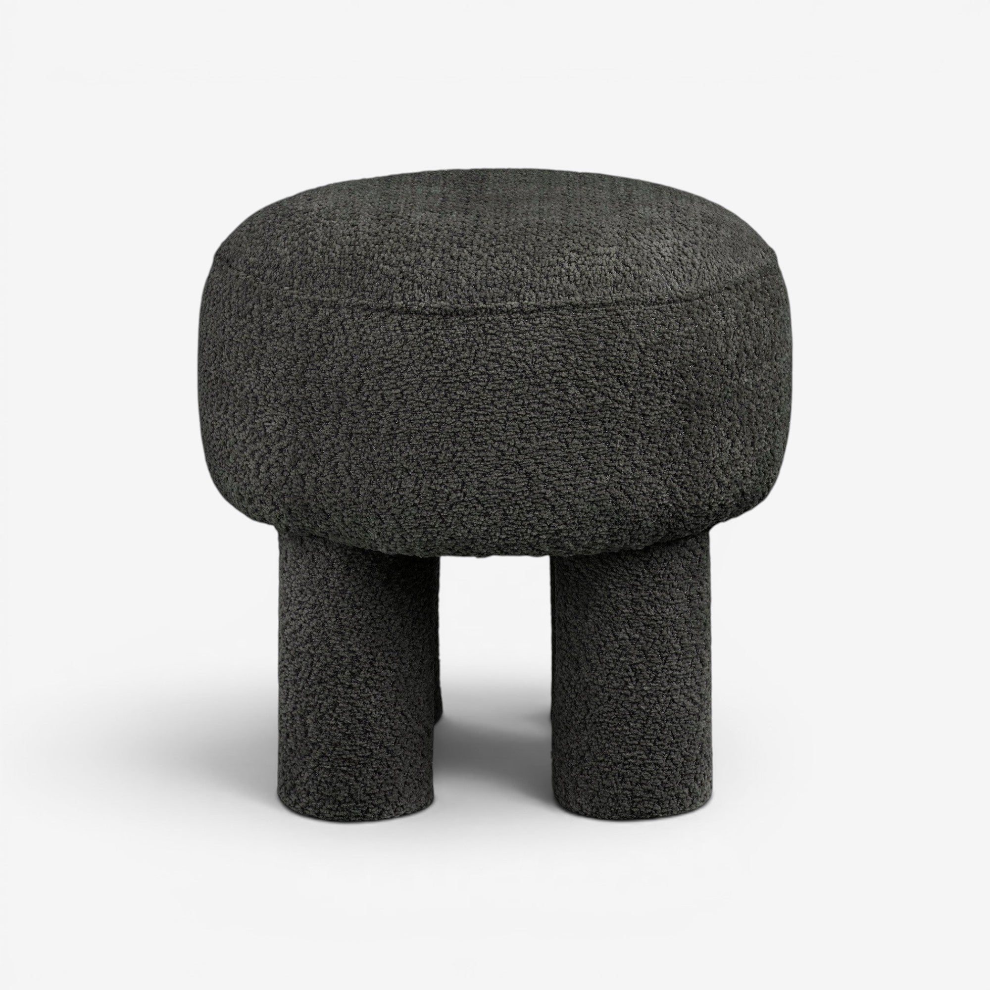 Kayu Living Canberra Pouf in charcoal grey. Round, textured polyester upholstery with four cylindrical legs. Modern accent seating or footrest.