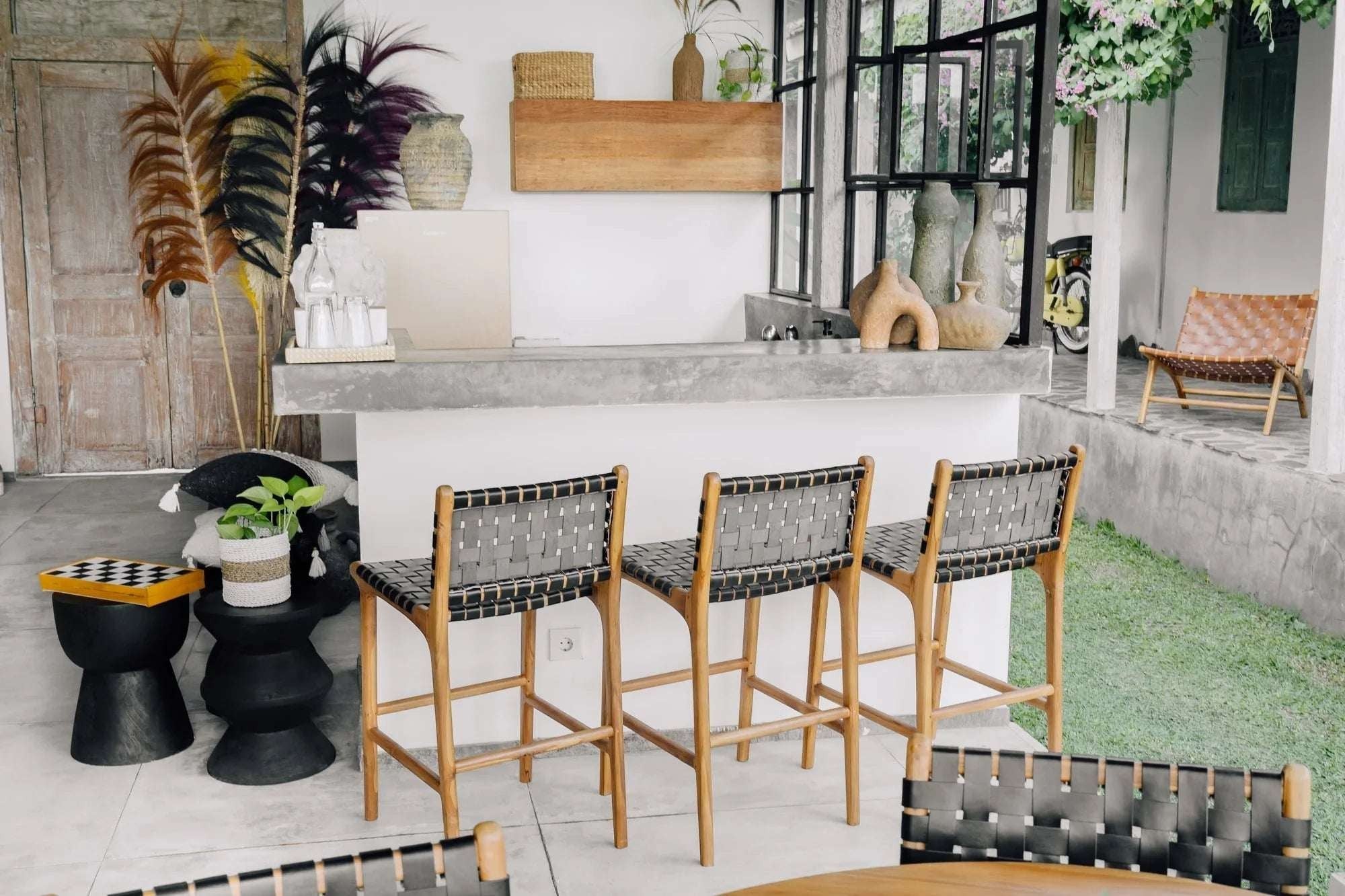 Kayu Living Umalas counter stool with woven black leather seat and natural teak wood frame. Modern bar stool.