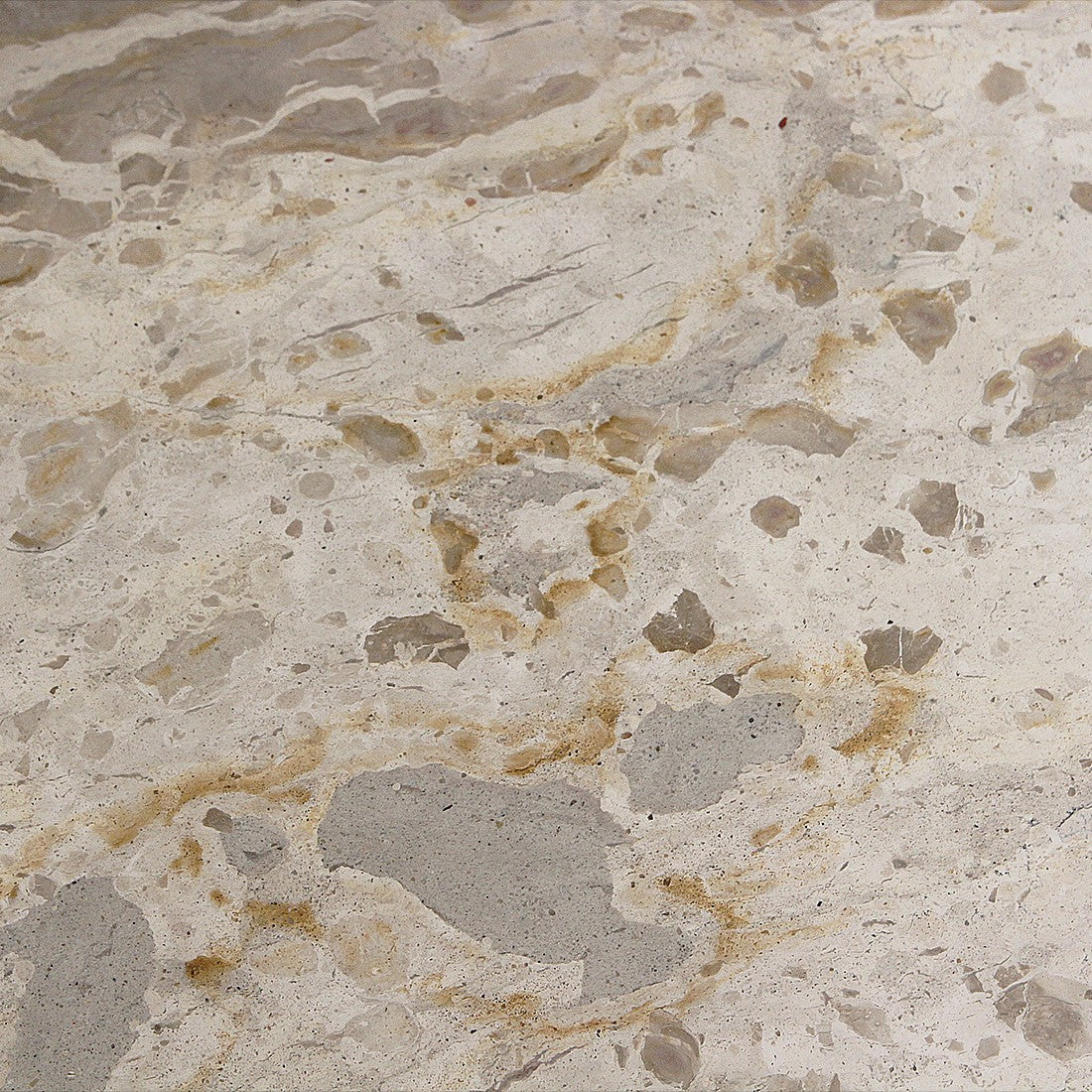 Close-up of the Kayu Living cream marble side table top showing unique natural veining and stone texture.