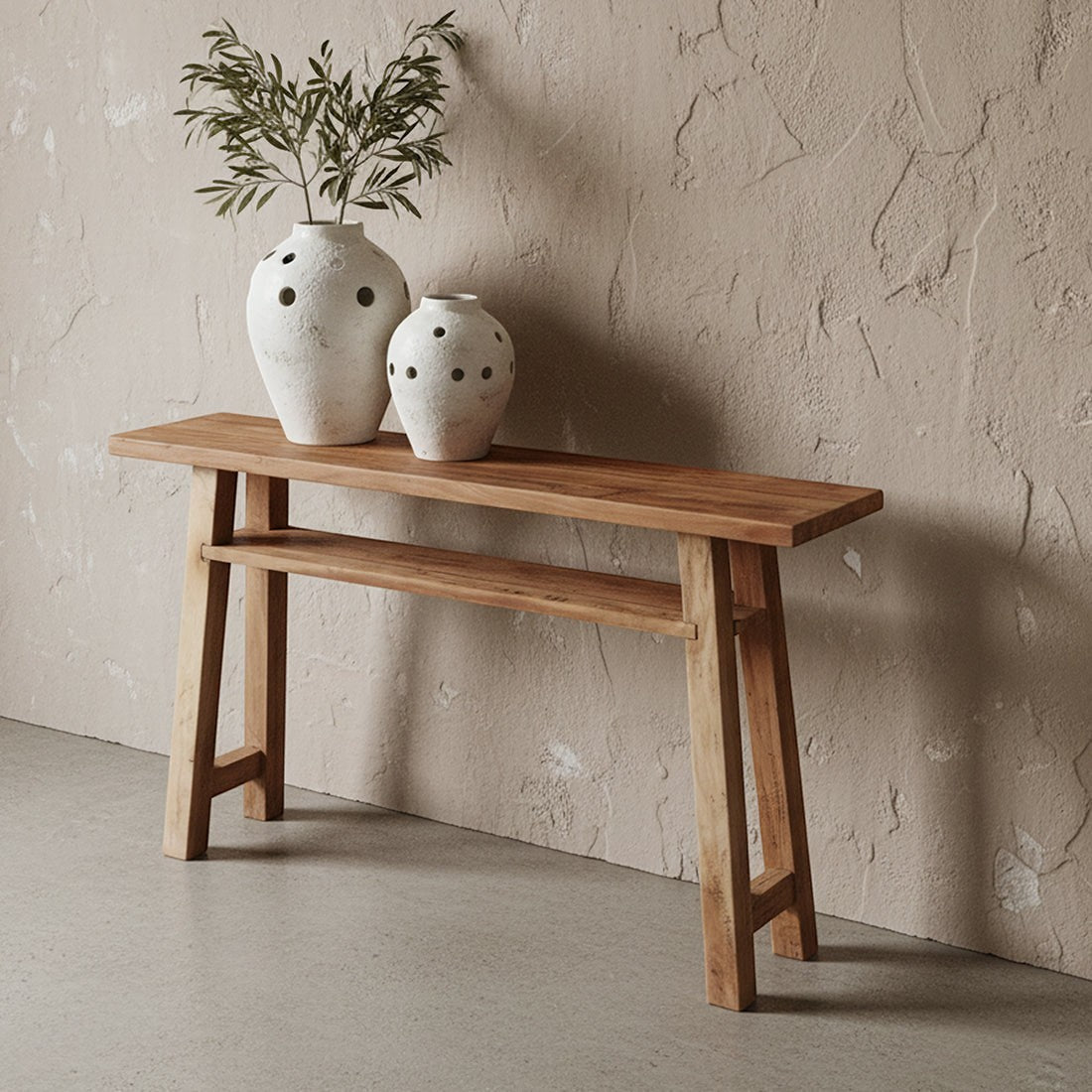Kayu Living Farmwood console table made from recycled wood with a lower shelf, styled with two rustic white vases.