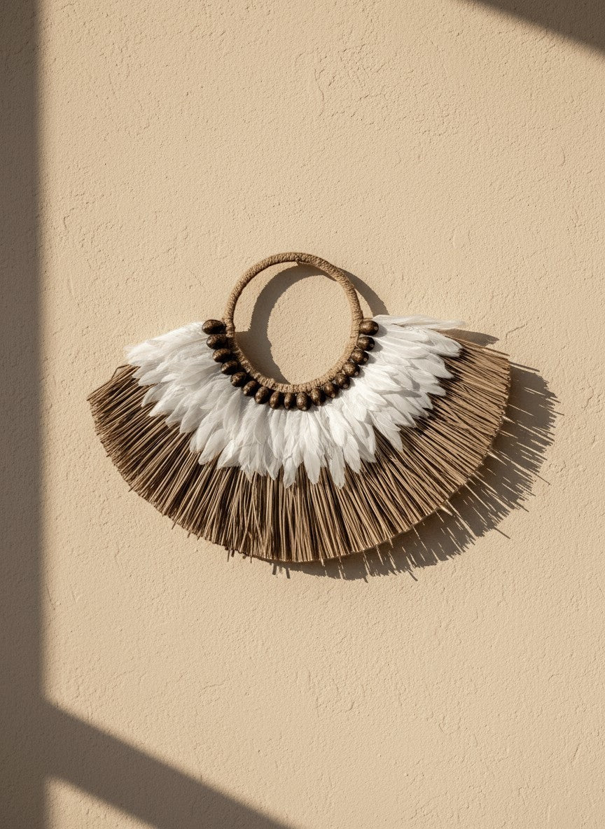 Kayu Living Flores Harmony wall decoration with white feathers, brown shells, and woven fibers. Handcrafted boho style.