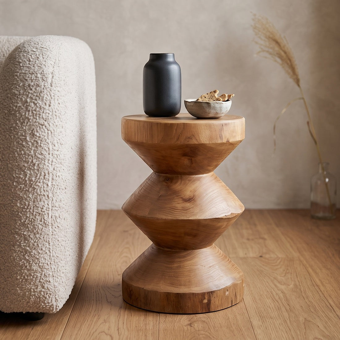 Kayu Living Forma Rizo handcrafted solid teak side table with a unique stacked geometric design in a living room.