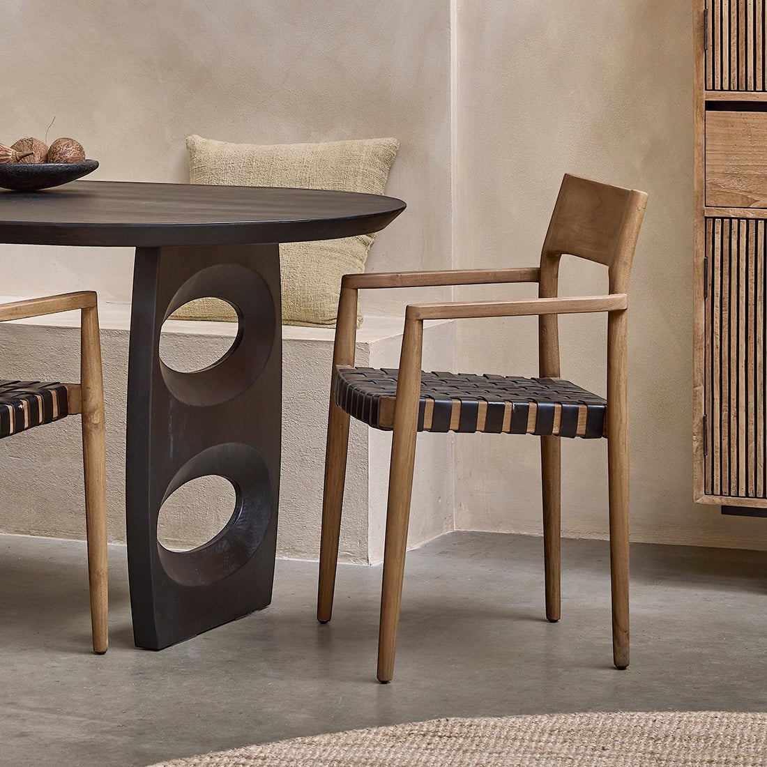 Kayu Living Freya dining chair with armrests in natural wood and black leather straps, ideal for industrial or boho interiors.