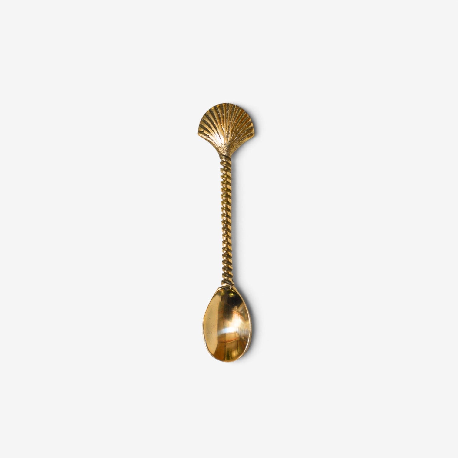 Kayu Living bohemian gold brass spoon featuring a decorative shell handle and twisted stem design.