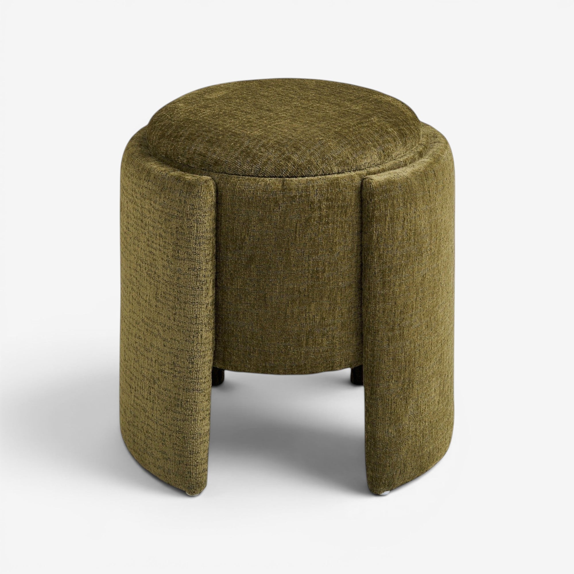 Kayu Living green round pouf upholstered in textured fabric with a curved base and high-density foam.