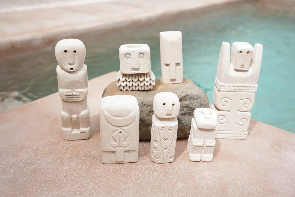 Kayu Living handmade stone figurines from Bali featuring unique carved gatekeeper designs in natural light stone.