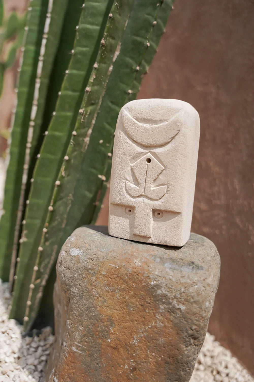 Kayu Living handmade stone guardian figurine with carved mystical symbols, natural beige finish, 14cm tall.