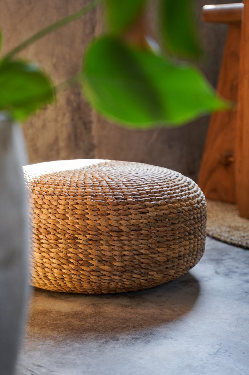 Kayu Living handcrafted natural water hyacinth pouf with organic woven texture for living room or bedroom decor.