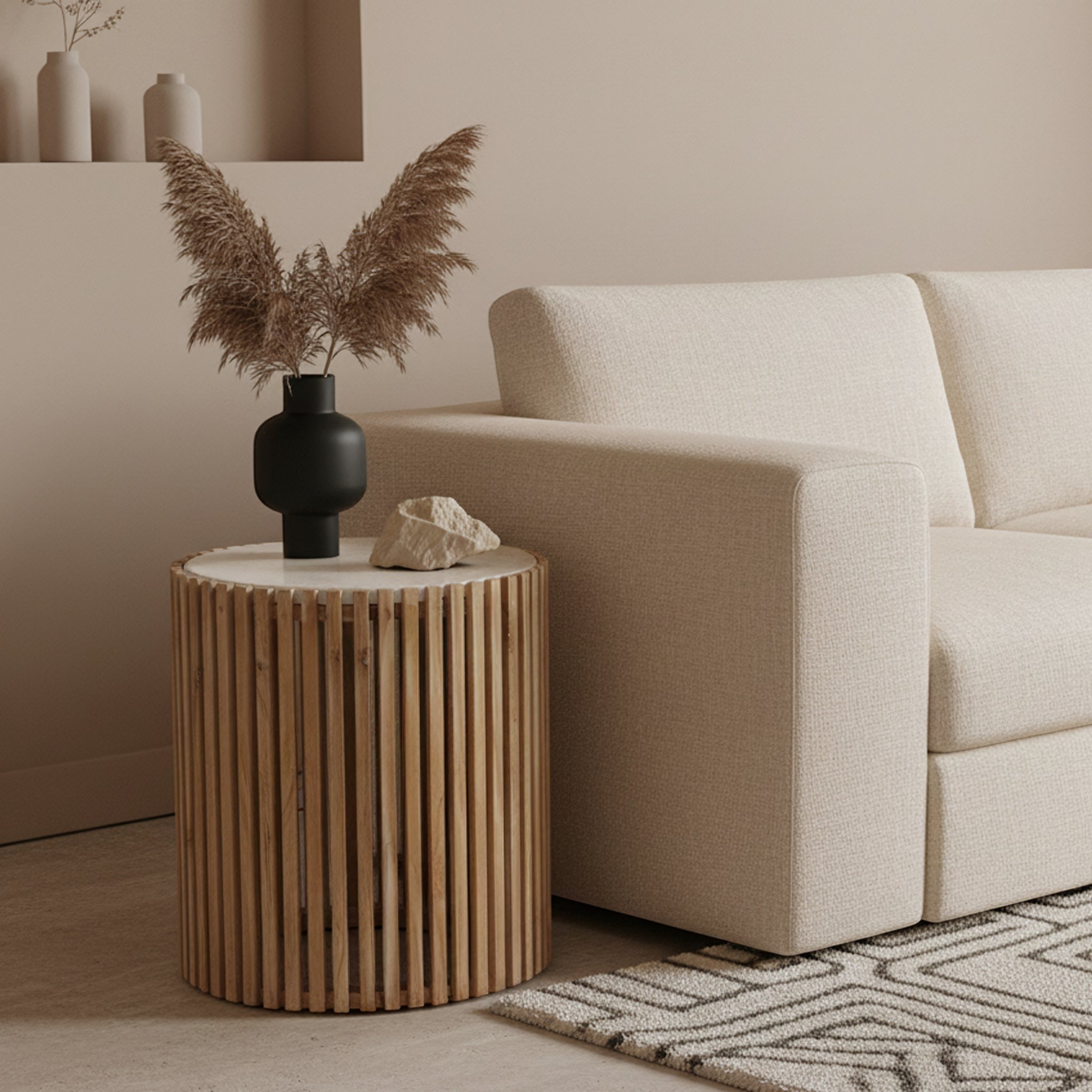 Kayu Living Infinity round side table with a white marble top and slatted natural Sungkai wood base beside a sofa.