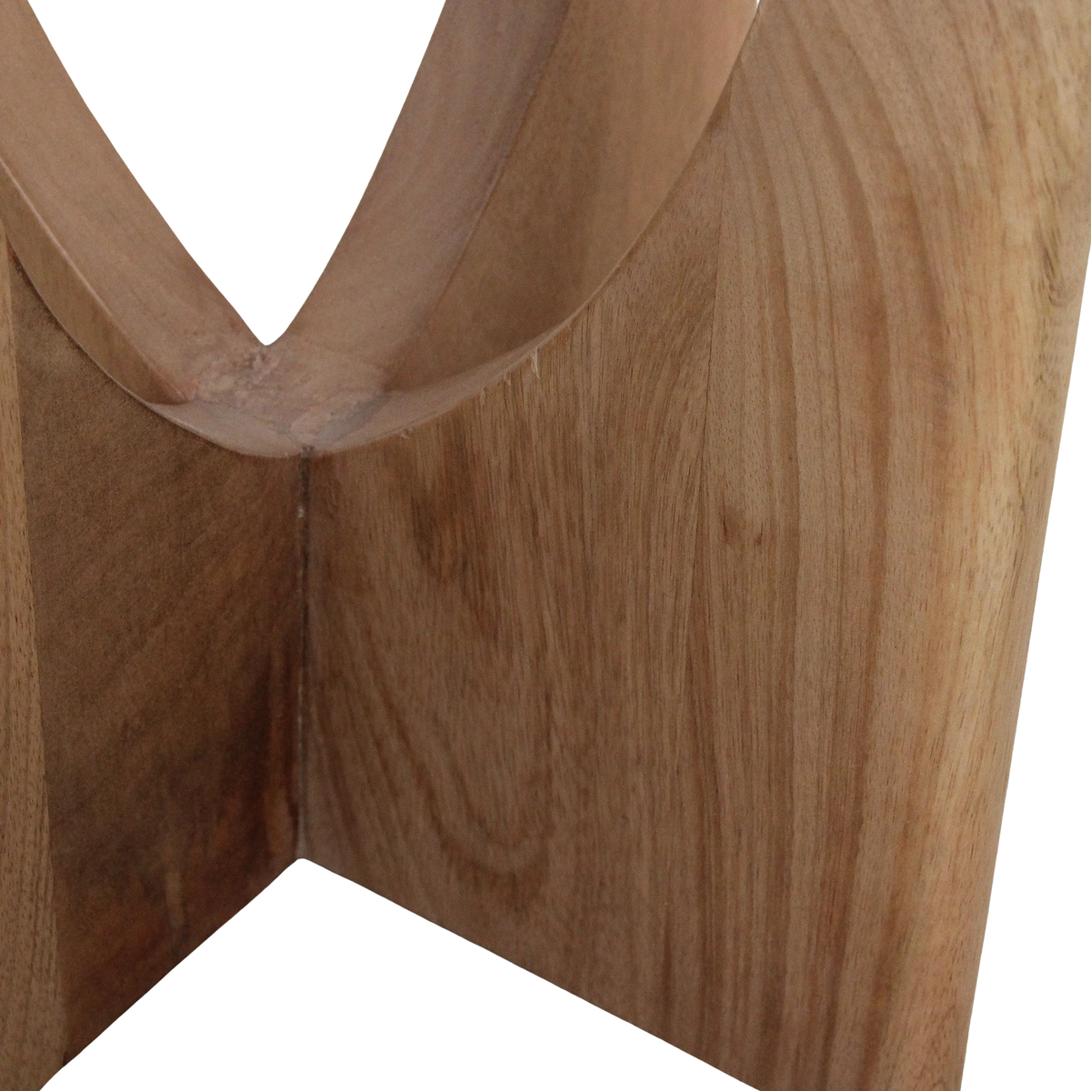 Close-up of the arched mango-wood base of a Kayu Living Kuching marble side table showing natural wood grain texture.