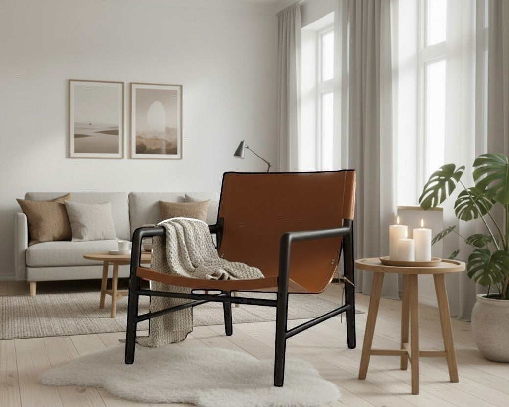 Kayu Living Marita armchair in dark brown teak with cognac leather seat and back, black frame.