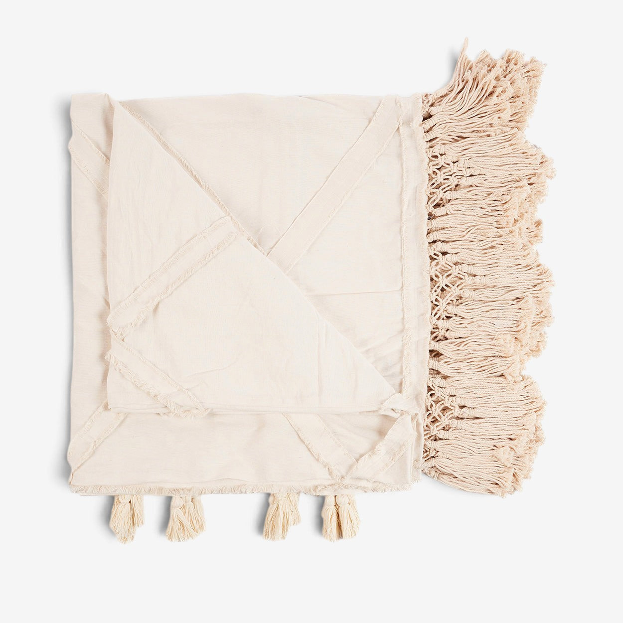 Kayu Living Berber Bed Throw in natural cotton with decorative fringe and tassel details, folded on a white background.