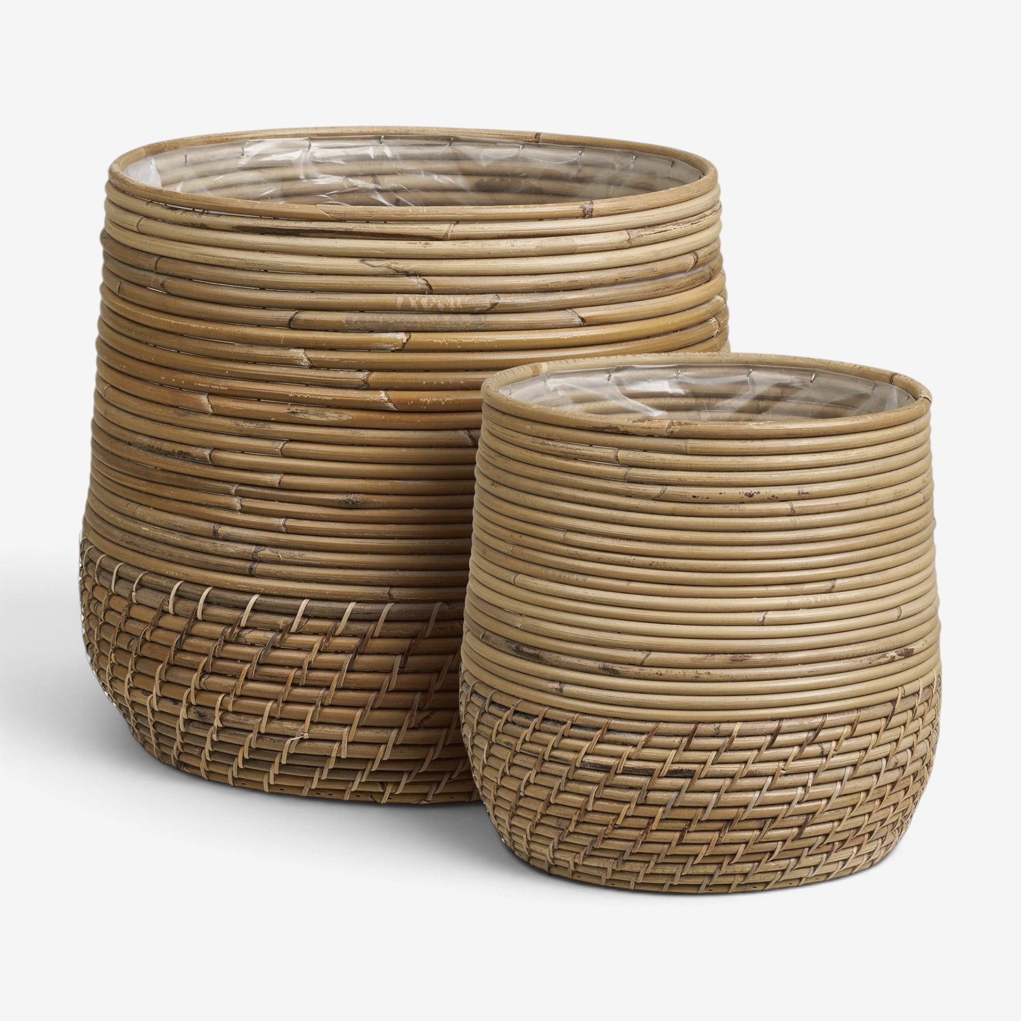 Kayu Living set of two handcrafted natural Kubu rattan baskets with organic woven texture and interior liners.