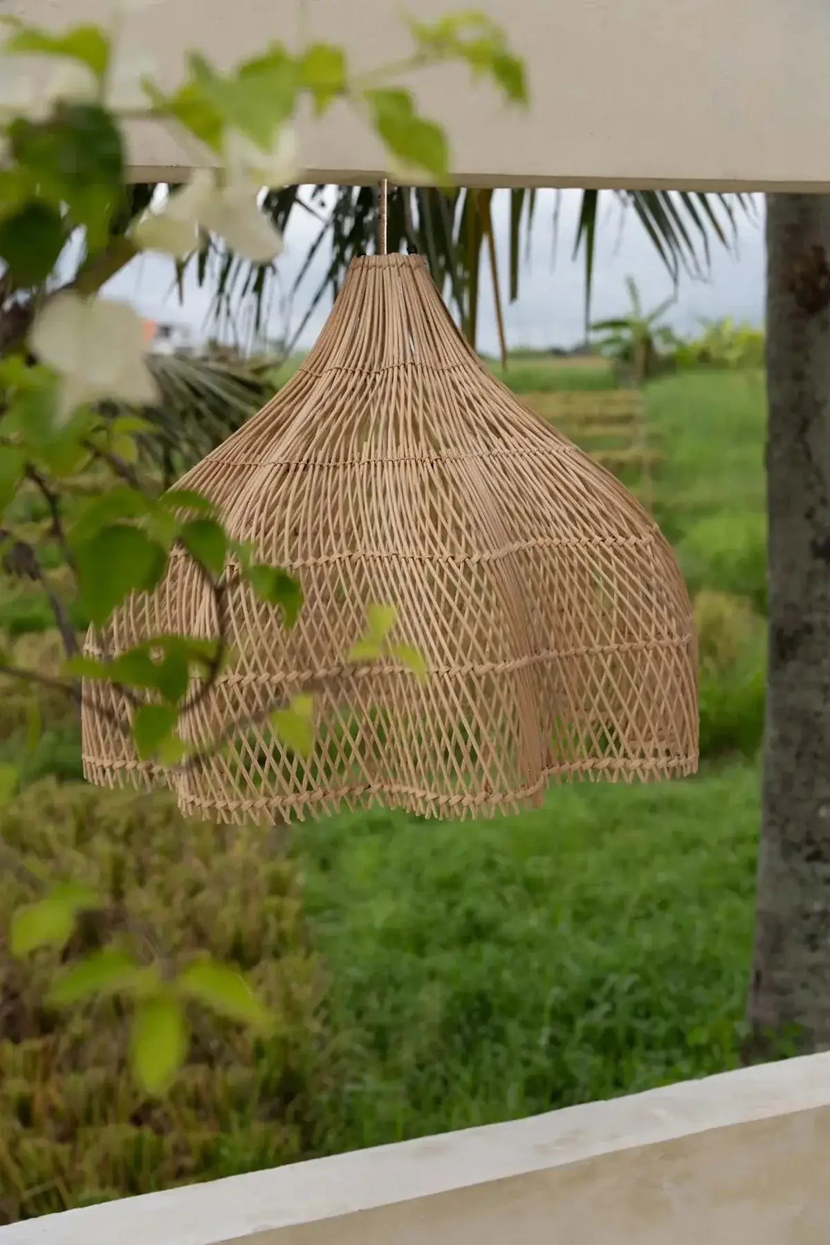 Kayu Living natural rattan pendant lamp with a unique shape and boho style, ideal for indoor or outdoor spaces.