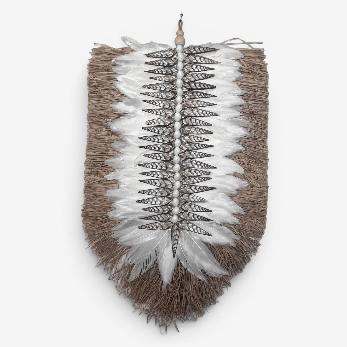 Kayu Living Nias wall decoration with white feathers, shells, and natural fibers. Coastal boho style.