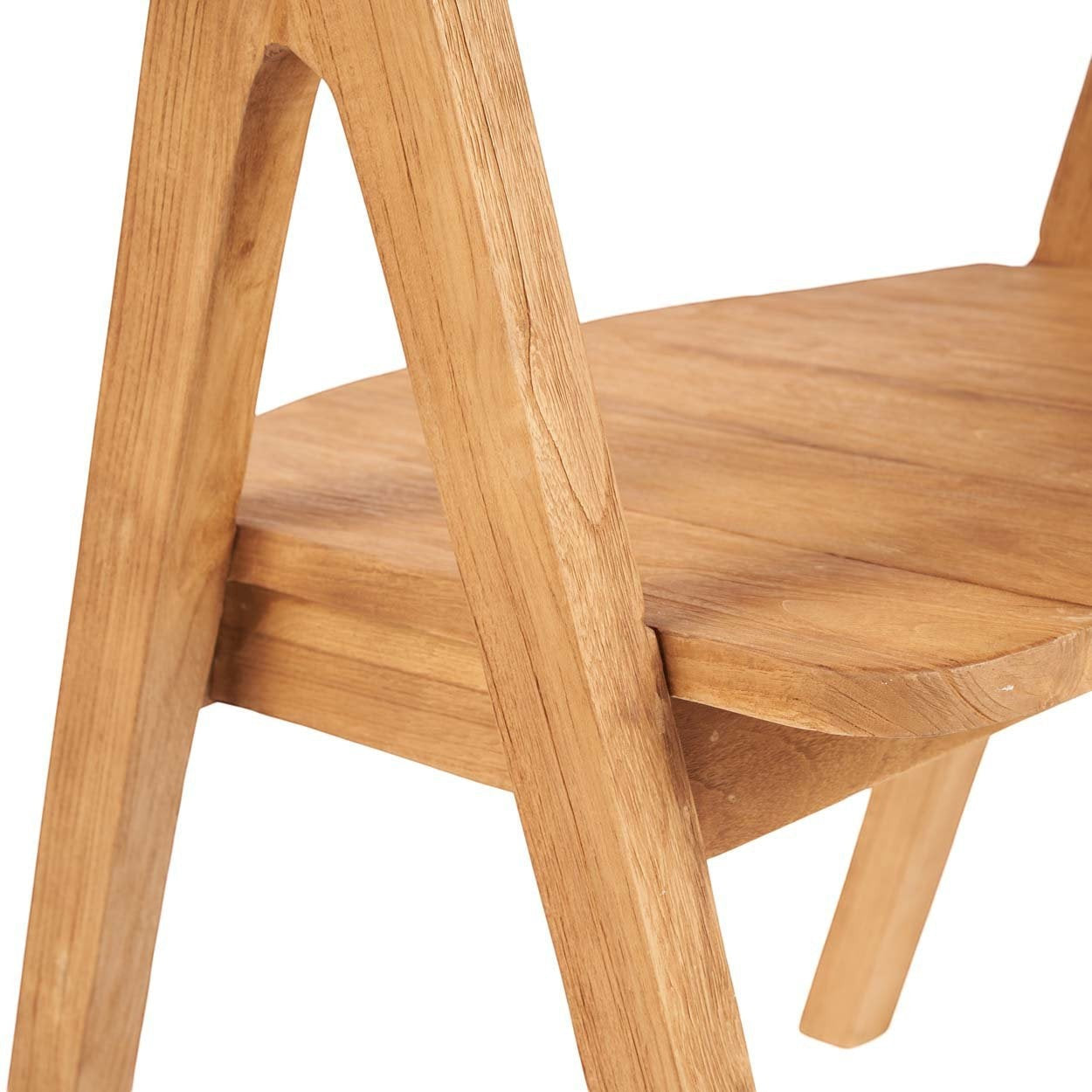 Kayu Living Nihi Sumba dining chair in natural teak with sculpted curves and crisp lines, suitable for indoor or outdoor use.