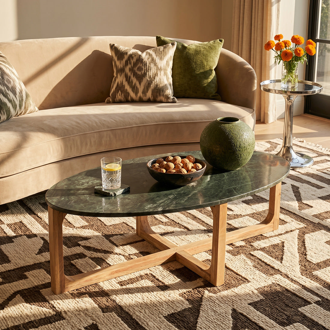 Kayu Living oval coffee table with a green marble top and sustainable mango wood base in a sunlit living room