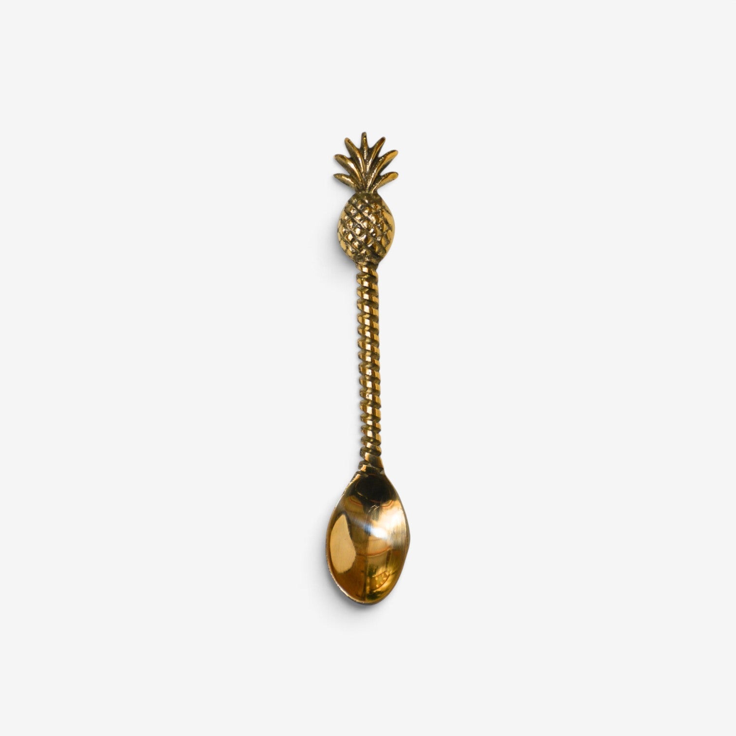 Kayu Living handcrafted gold brass spoon with a detailed pineapple handle, perfect for bohemian table decor.