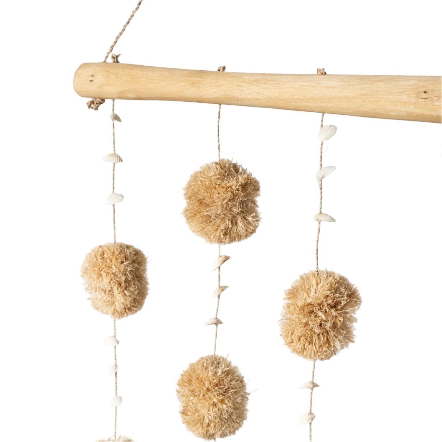 Kayu Living natural tan pom pom wall hanging with shells on driftwood.