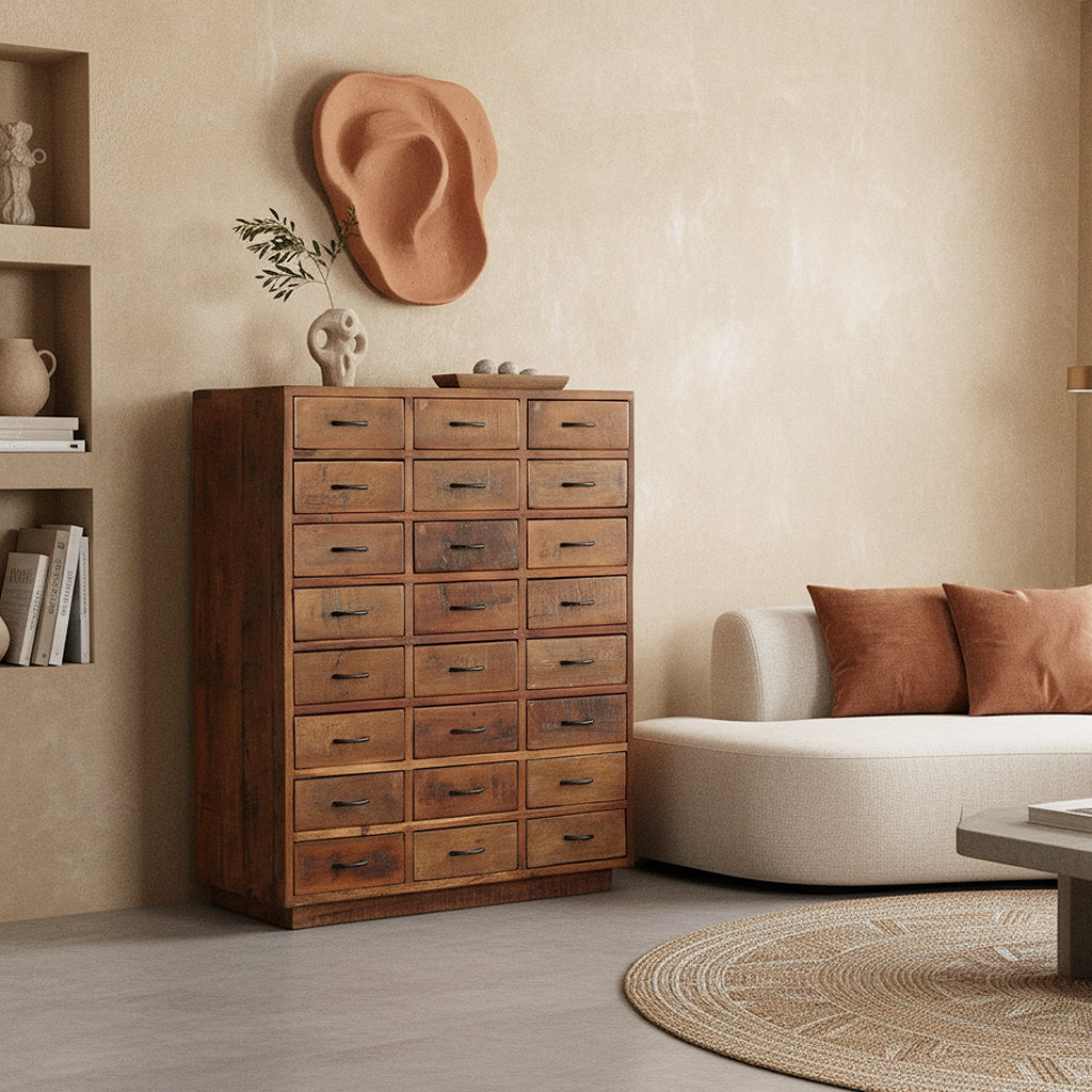 Kayu Living brown reclaimed hardwood factory cabinet with 24 drawers in a minimalist industrial living room.