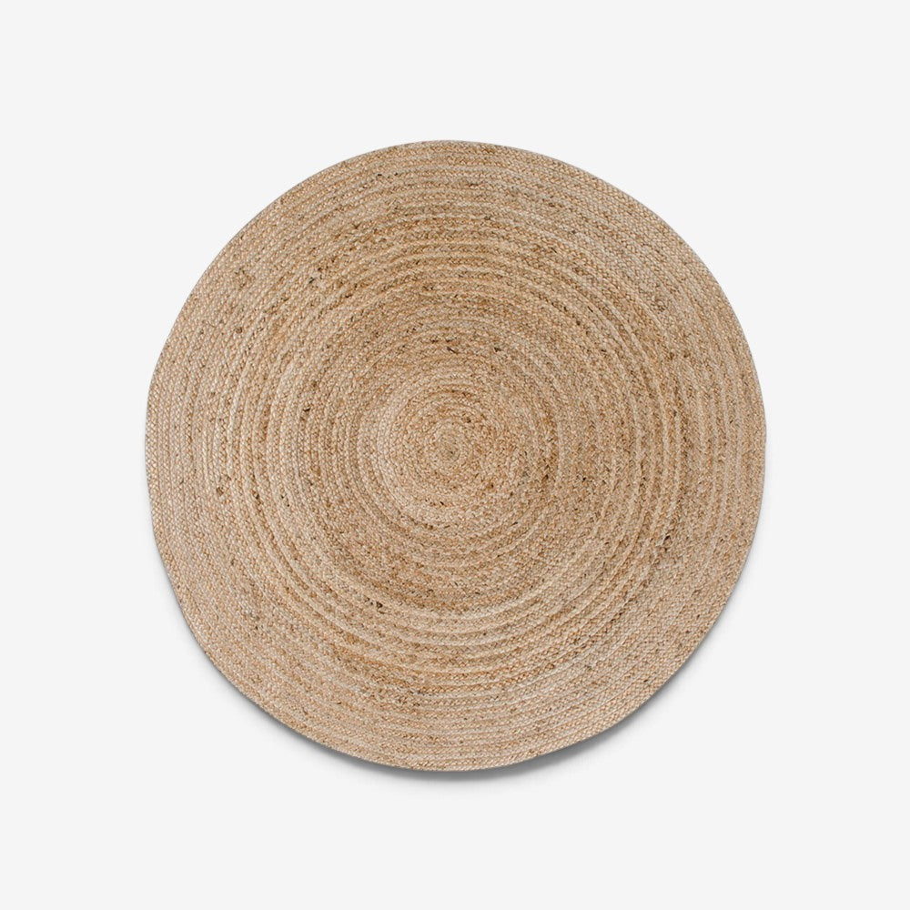Kayu Living round handwoven natural jute rug with a textured braided design, 90 cm diameter.