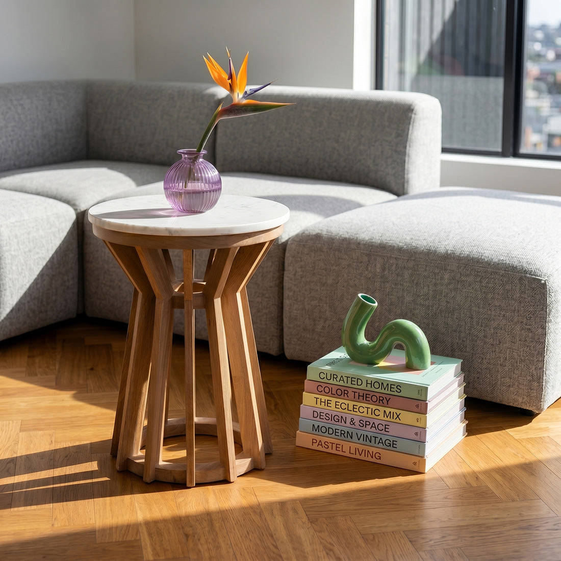 Kayu Living Sarawak marble side table with a round white marble top and open mango-wood base in a living room.