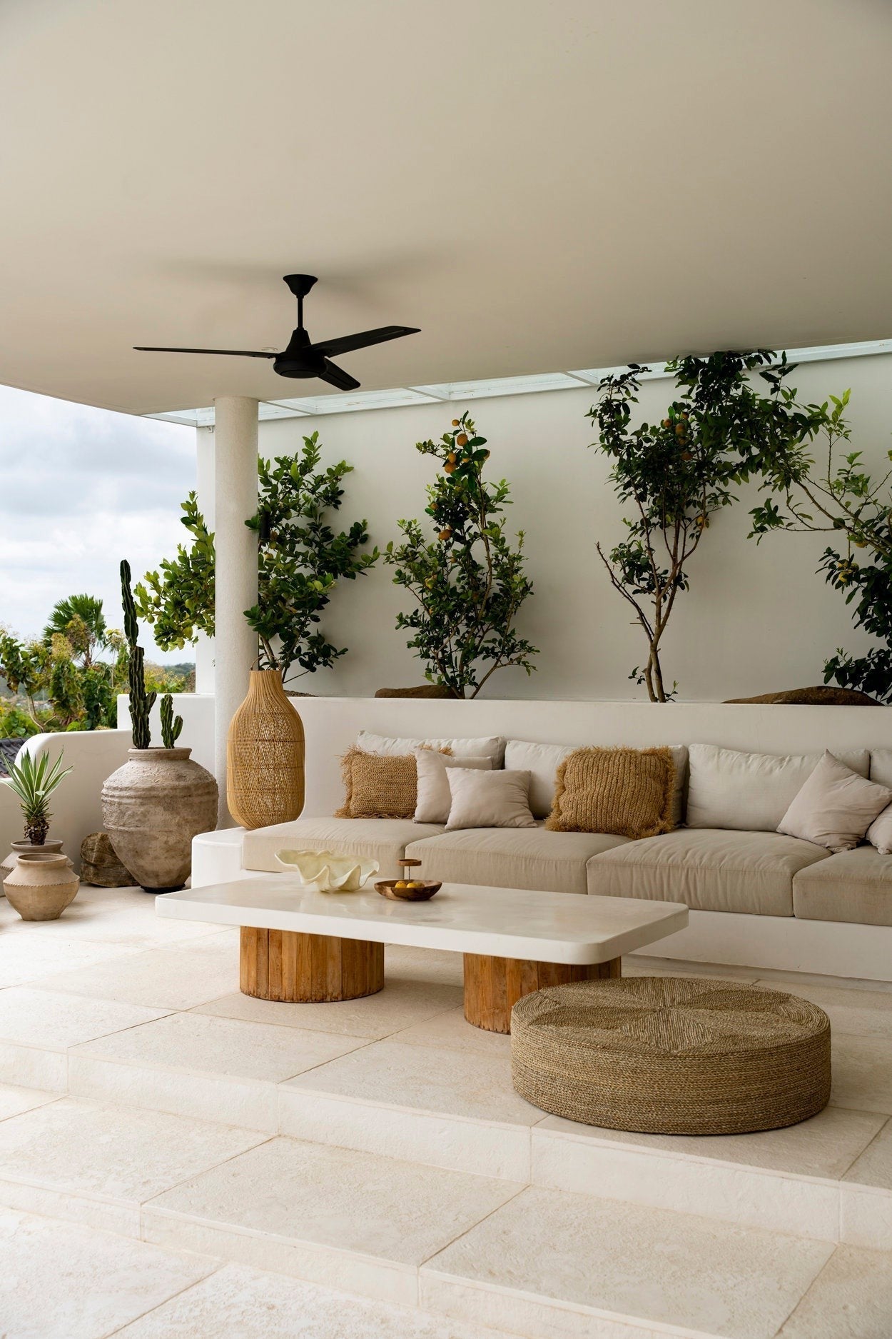 Kayu Living The Huge Pouf, a large round handcrafted seagrass floor cushion with woven texture on a patio.