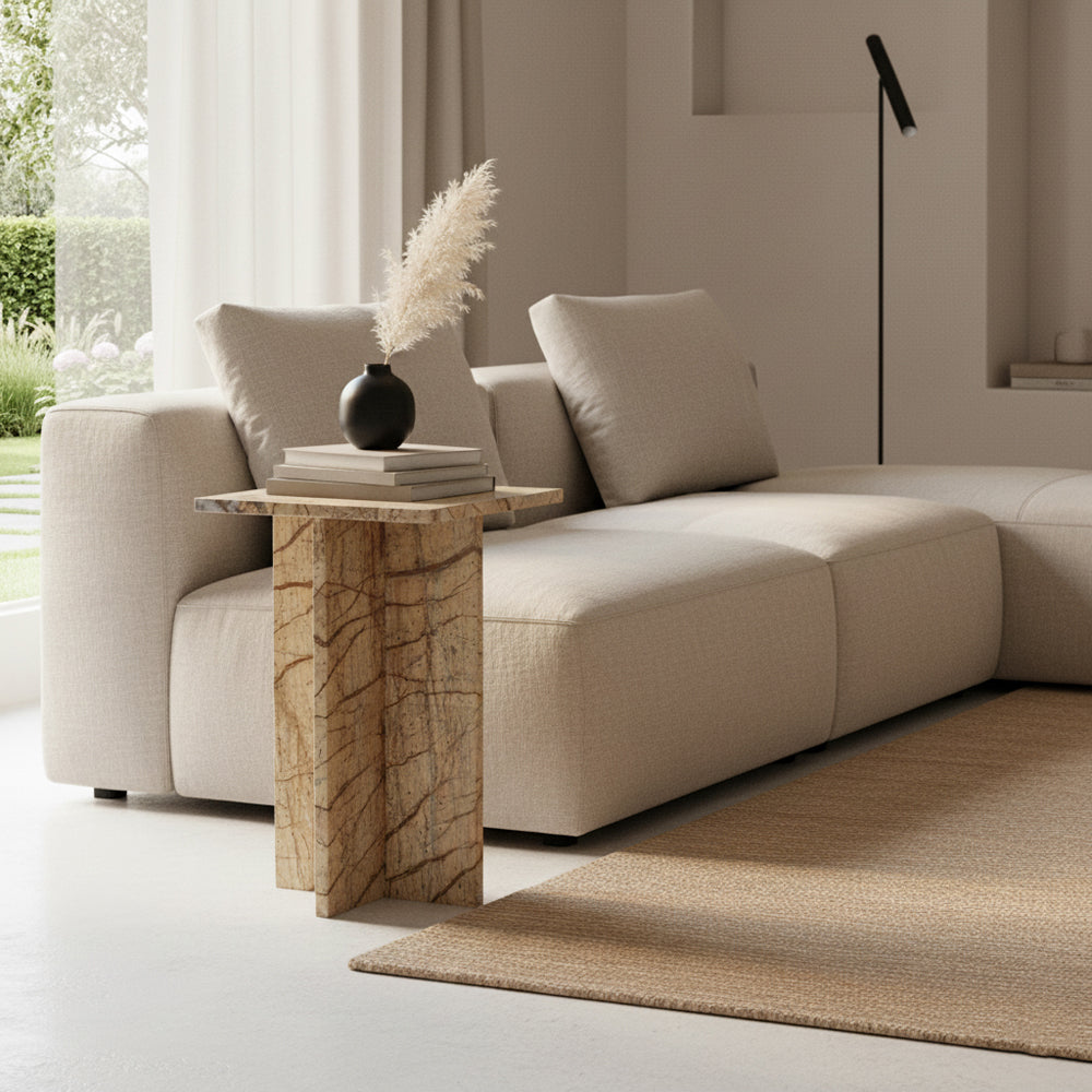 Kayu Living Seoel Bizar square side table in warm-toned marble with a cross base, styled next to a beige sofa.