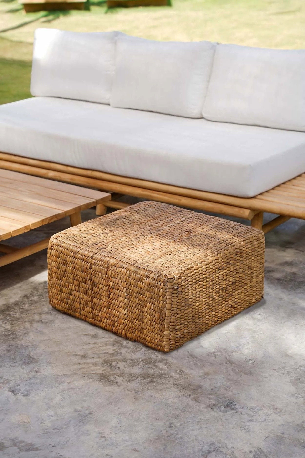 Kayu Living square water-hyacinth pouf in natural tan, featuring a woven texture for indoor or outdoor decor.