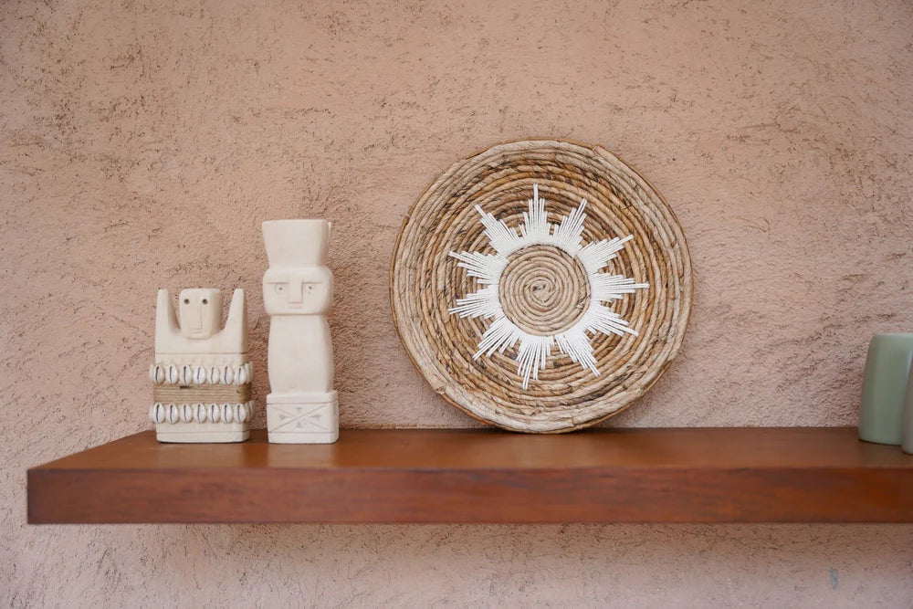 Kayu Living handmade stone guardian figurines from Bali with natural finish displayed on a wooden shelf.