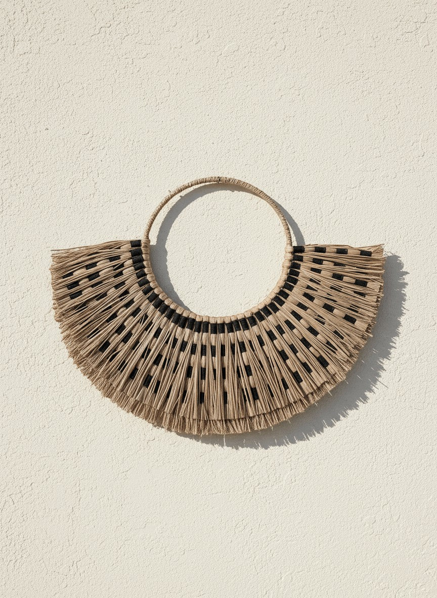 Kayu Living Sumba Natural wall decoration, handwoven beige organic fibers with black details, fan shape.