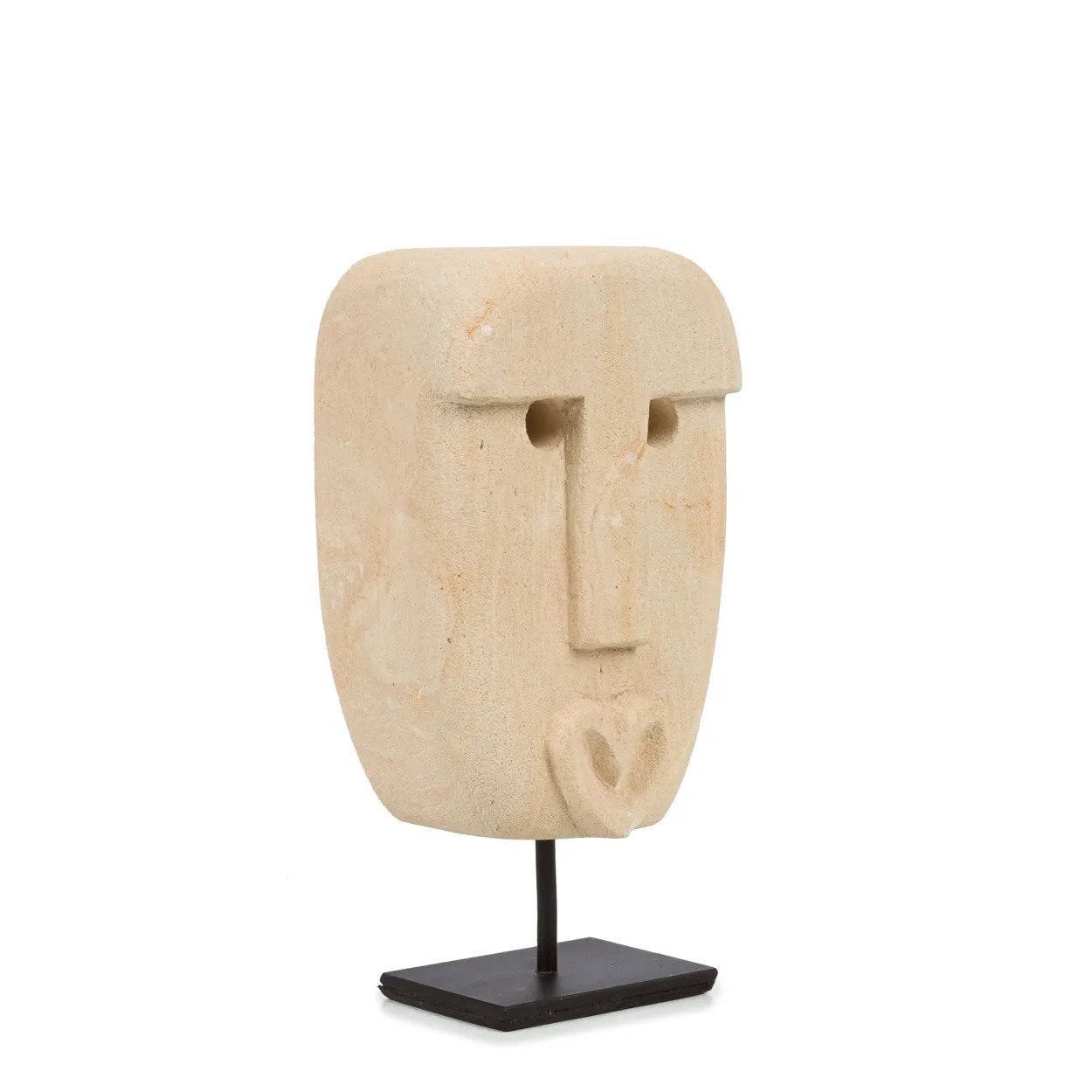 Kayu Living hand-carved sandstone Sumba stone statue with a minimalist face design on a black metal display stand.