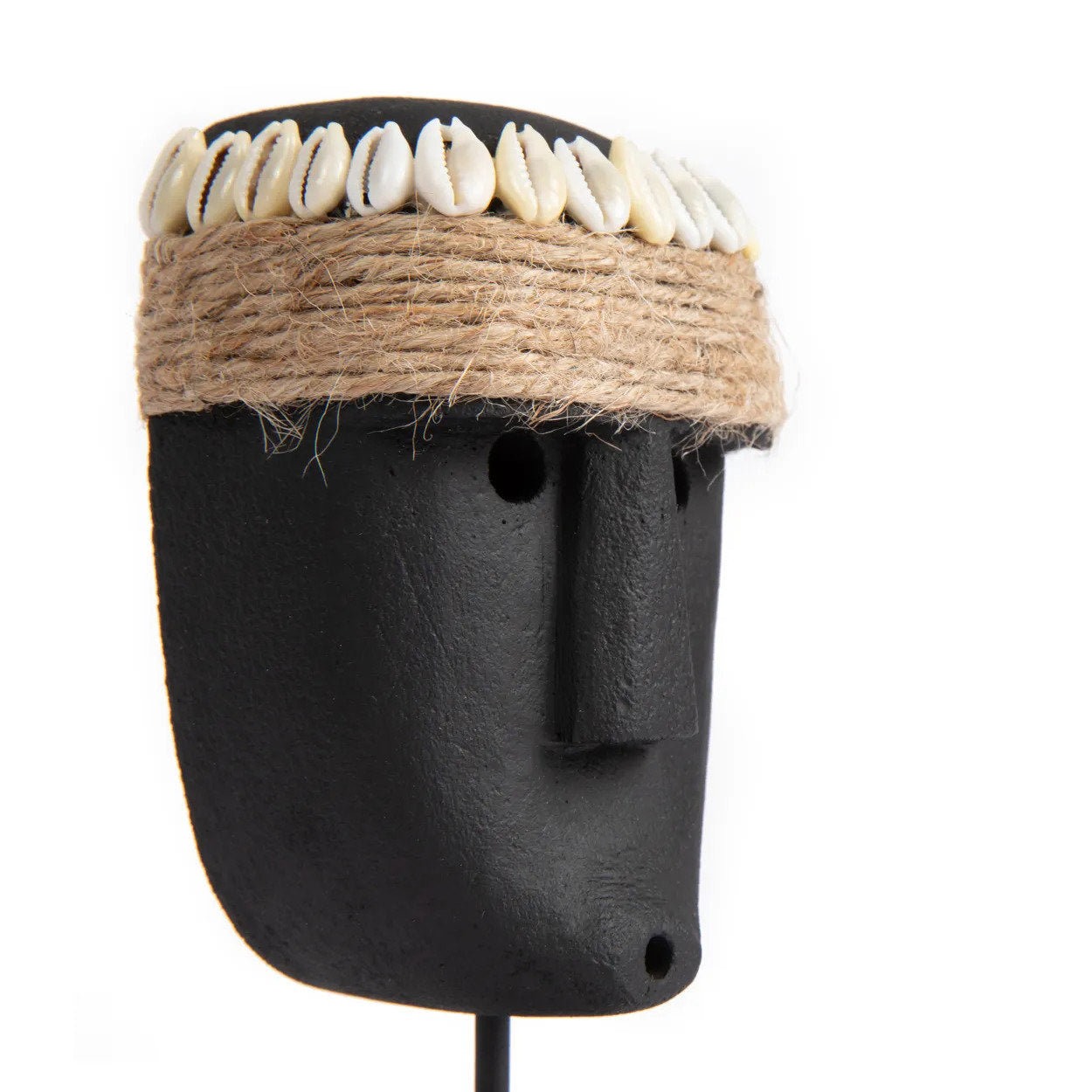 Kayu Living hand-carved black sandstone Sumba statue featuring a jute rope and seashell headband on a display stand.