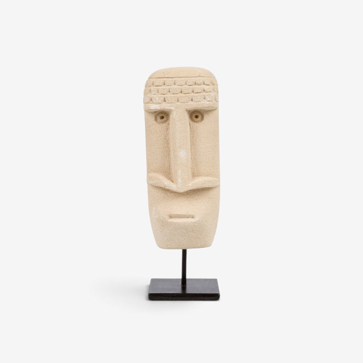 Kayu Living hand-carved beige sandstone Sumba statue on a black metal stand, featuring traditional tribal design.