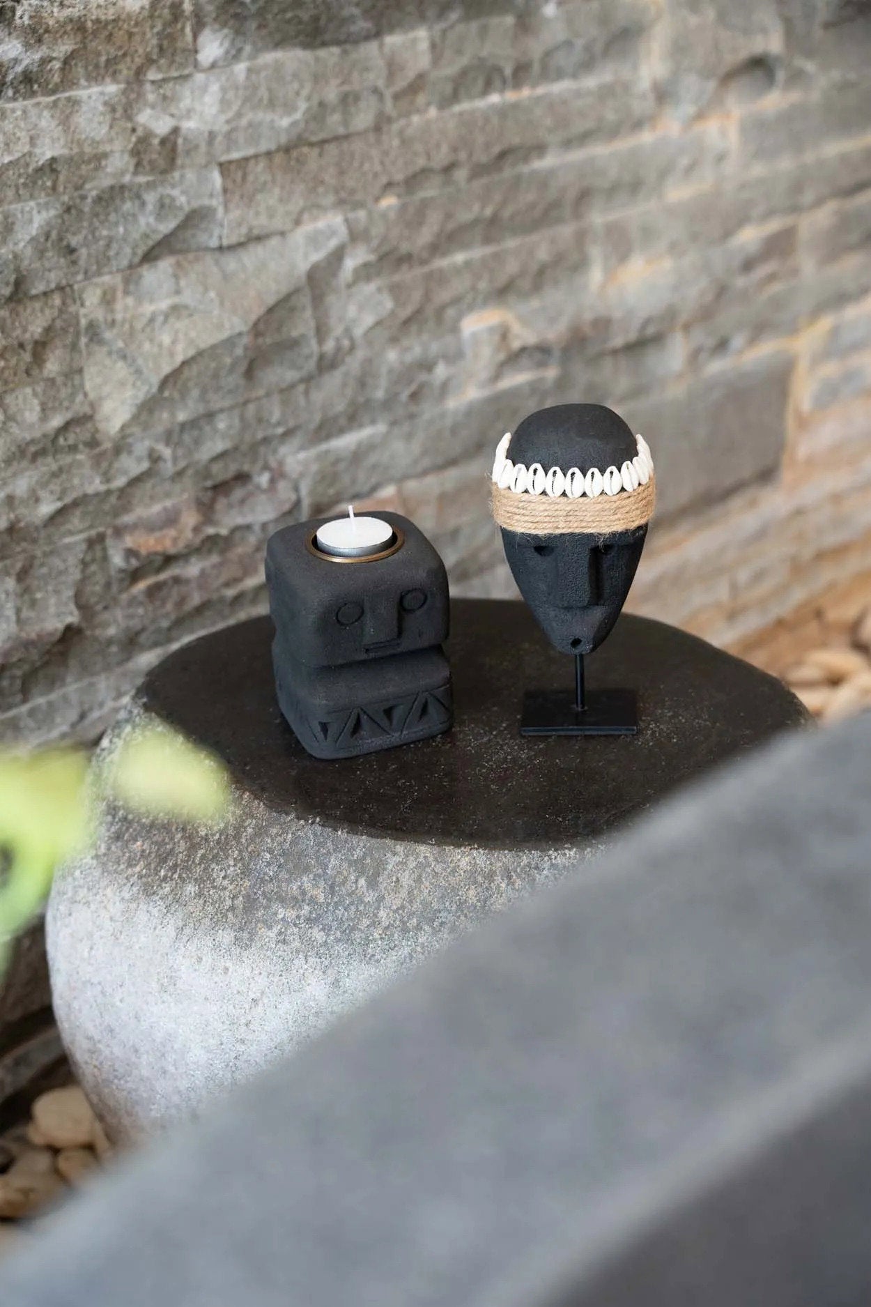 Kayu Living hand-carved black sandstone Sumba stone statue and candle holder on a stone pedestal