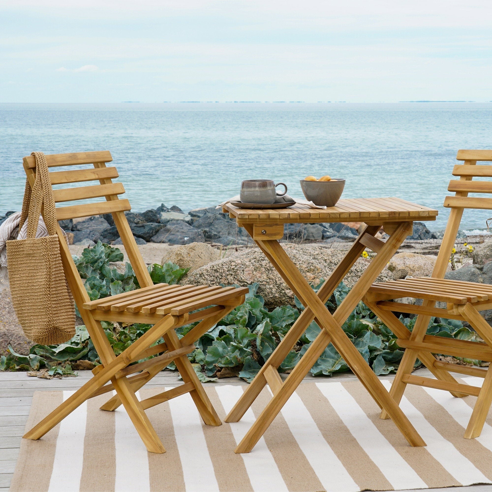 Kayu Living elegant natural teak coffee set with two chairs and a table, perfect for outdoor seating.