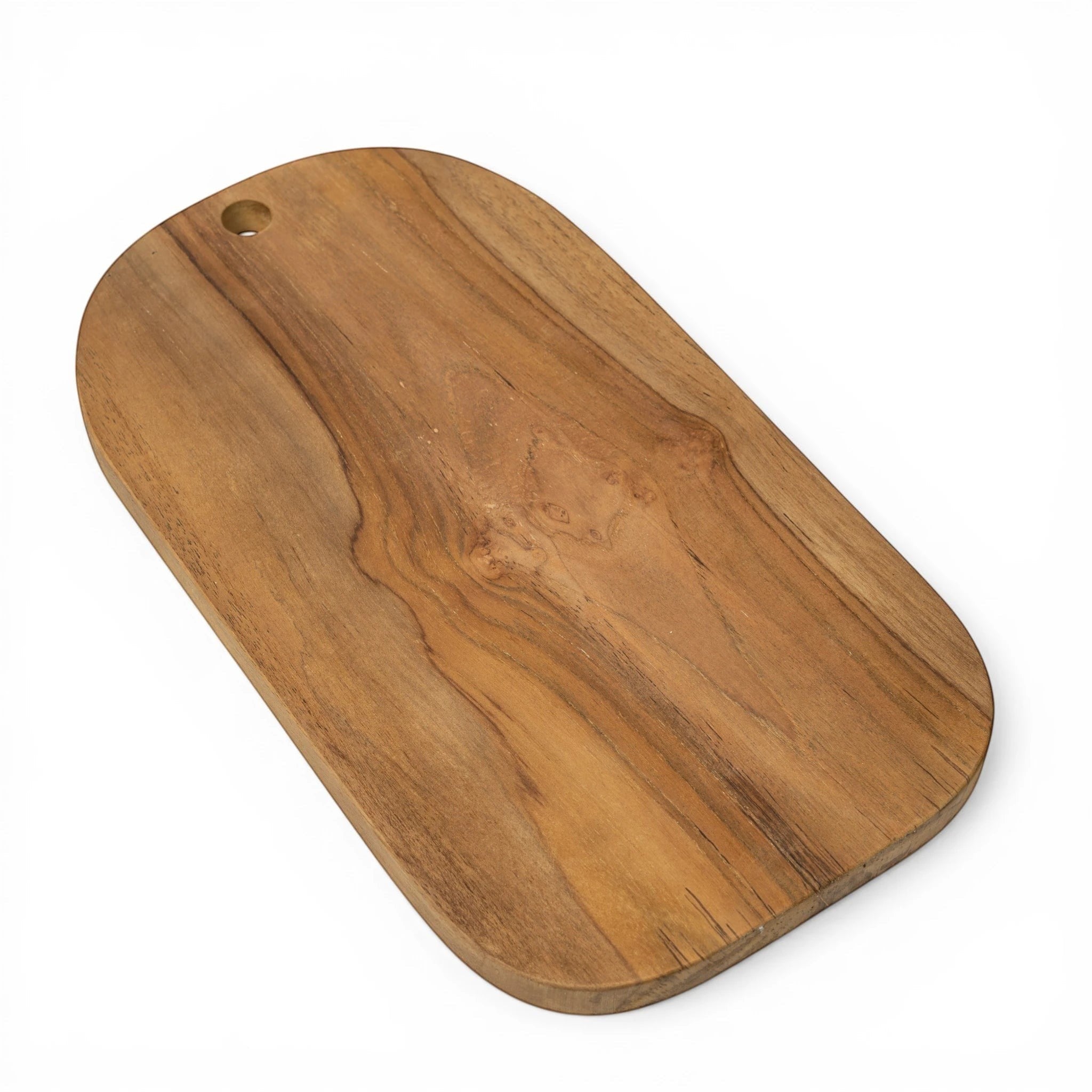 Kayu Living handcrafted teak wood cutting board with a smooth finish and hanging hole. Natural wood grain.