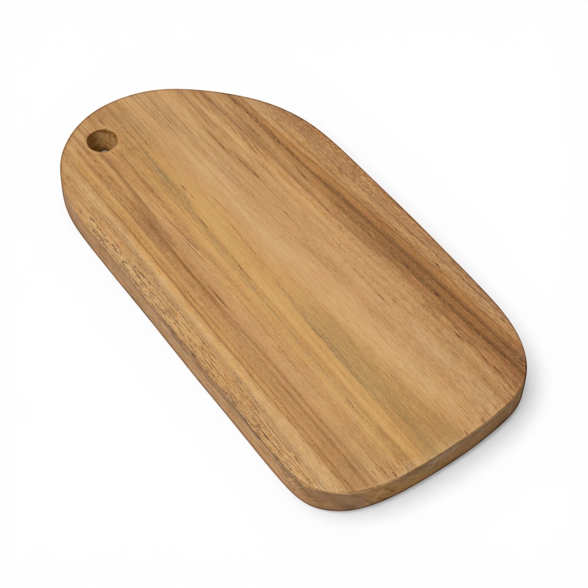 Kayu Living handcrafted teak wood cutting board with rounded edges and a hanging hole. Natural wood grain.